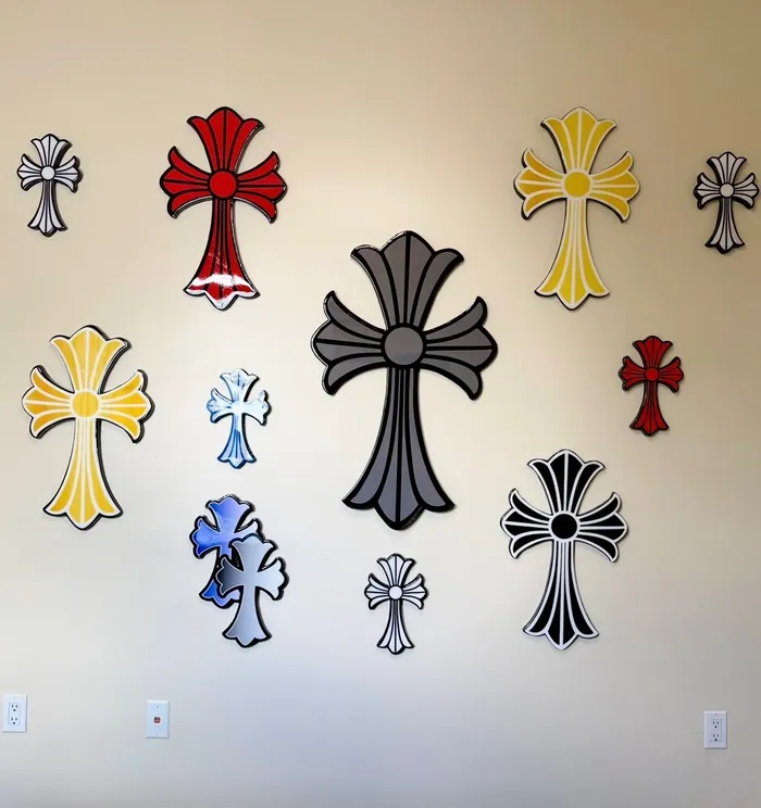 Nine glossy epoxy crosses in different colours arranged on a wall