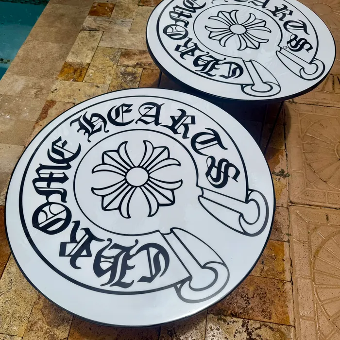 Two round epoxy tables with gothic lettering, on hairpin legs